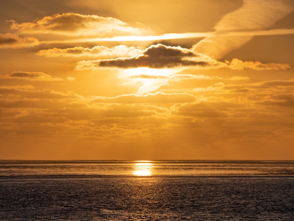 a large body of water under a cloudy sky