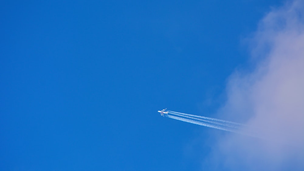 a jet plane flying through a blue sky