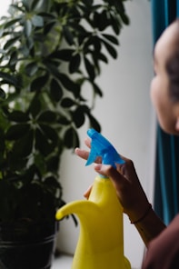 a woman is holding a blue and yellow banana