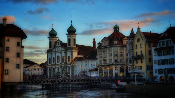 a river with a bridge and buildings in the background