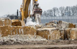 a bulldozer digging through a pile of rubble