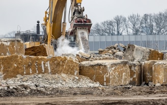 a bulldozer digging through a pile of rubble