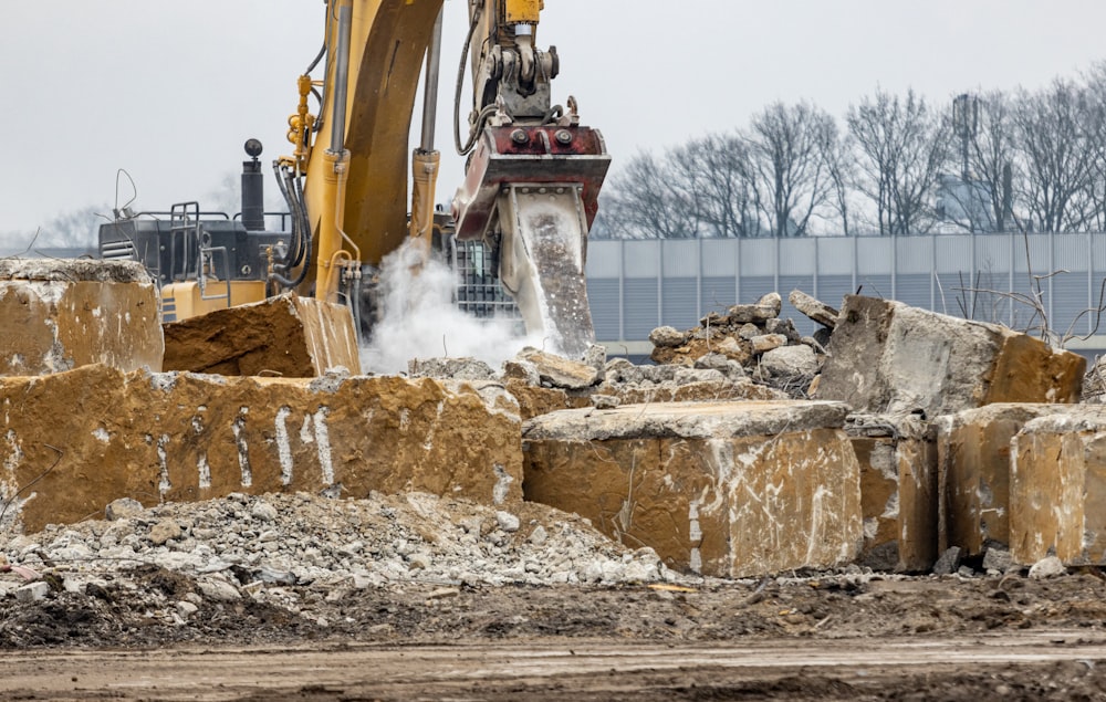 a bulldozer digging through a pile of rubble