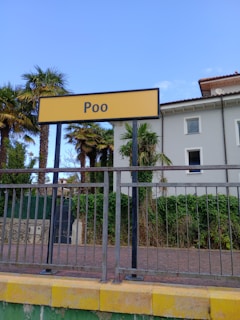 a fenced in area with a sign that says poo