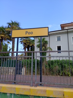 a fenced in area with a sign that says poo