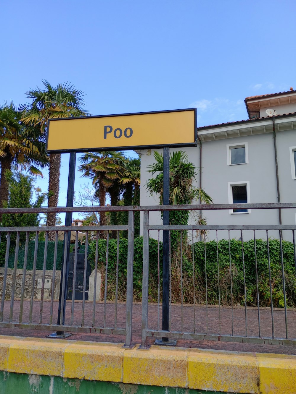 a fenced in area with a sign that says poo