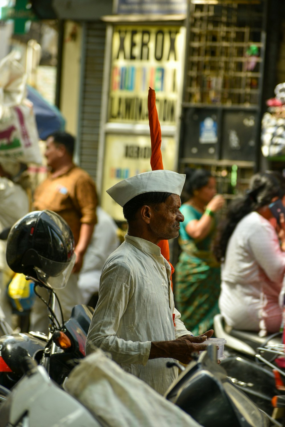 a man wearing a hat and holding an umbrella