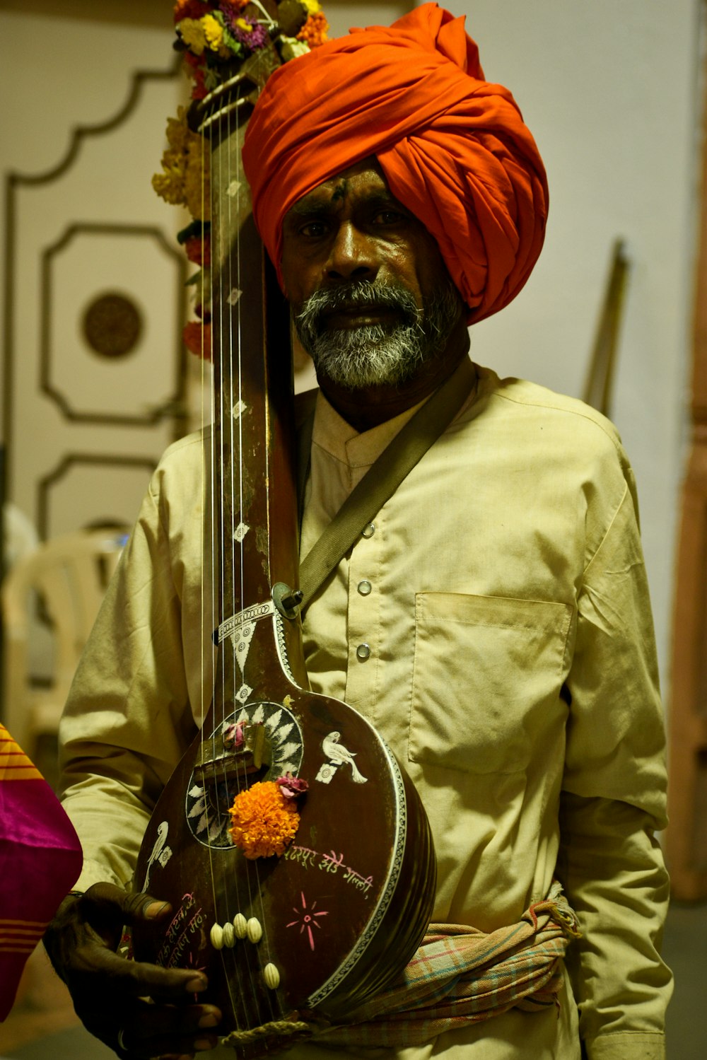 a man in a turban holding a guitar