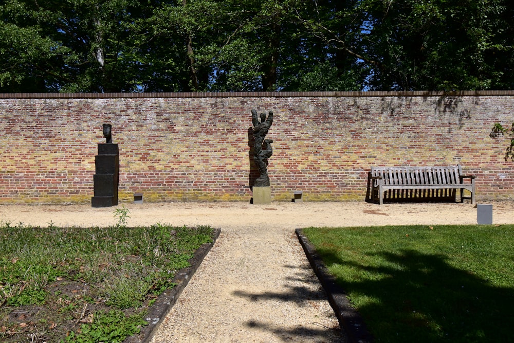 a brick wall with a wooden bench in front of it