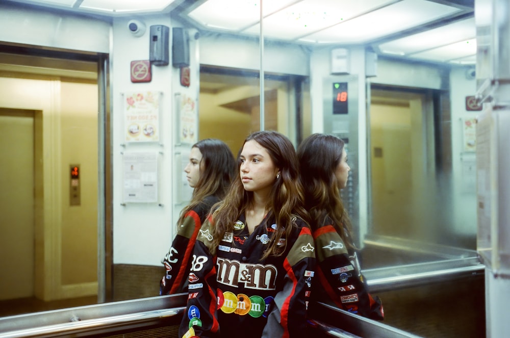 a group of women riding down an escalator