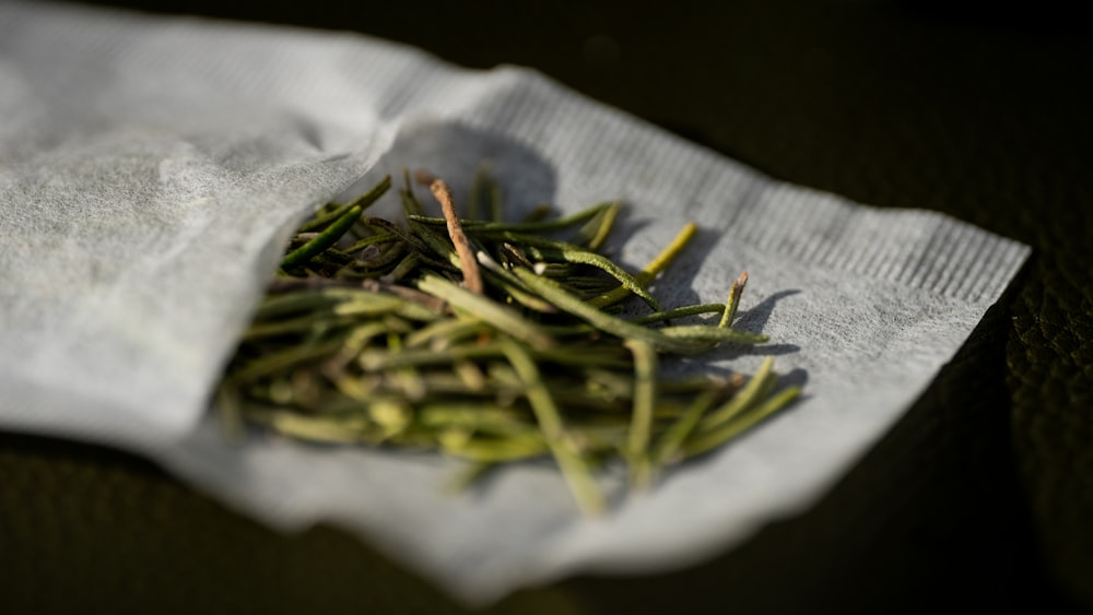 a pile of green tea sitting on top of a napkin