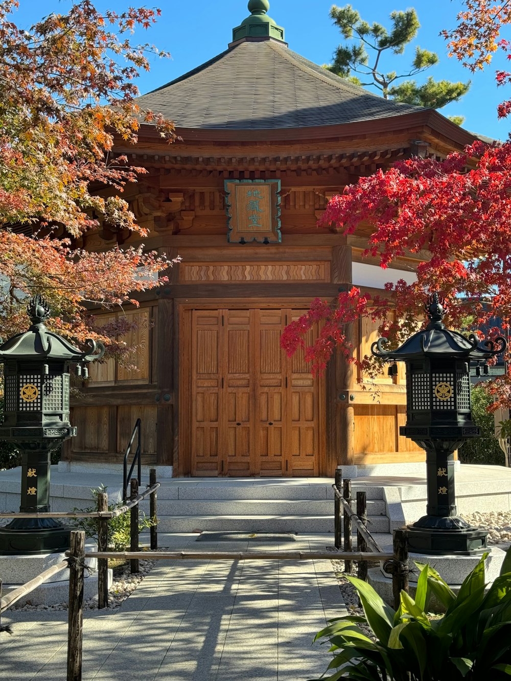 a wooden building with a clock on the front of it