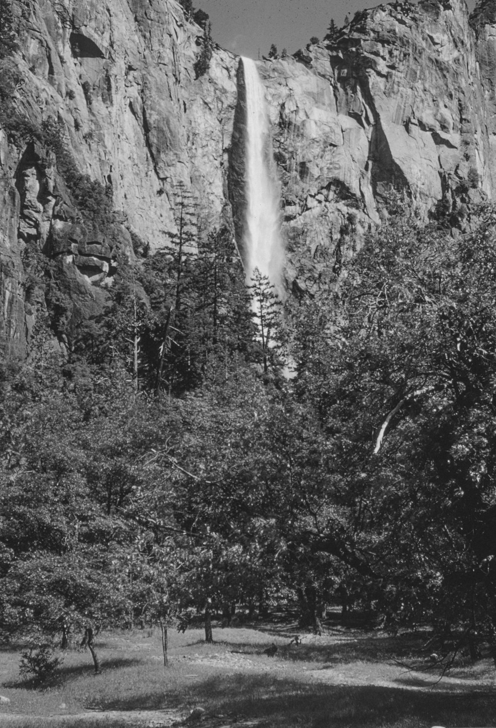 a black and white photo of a waterfall