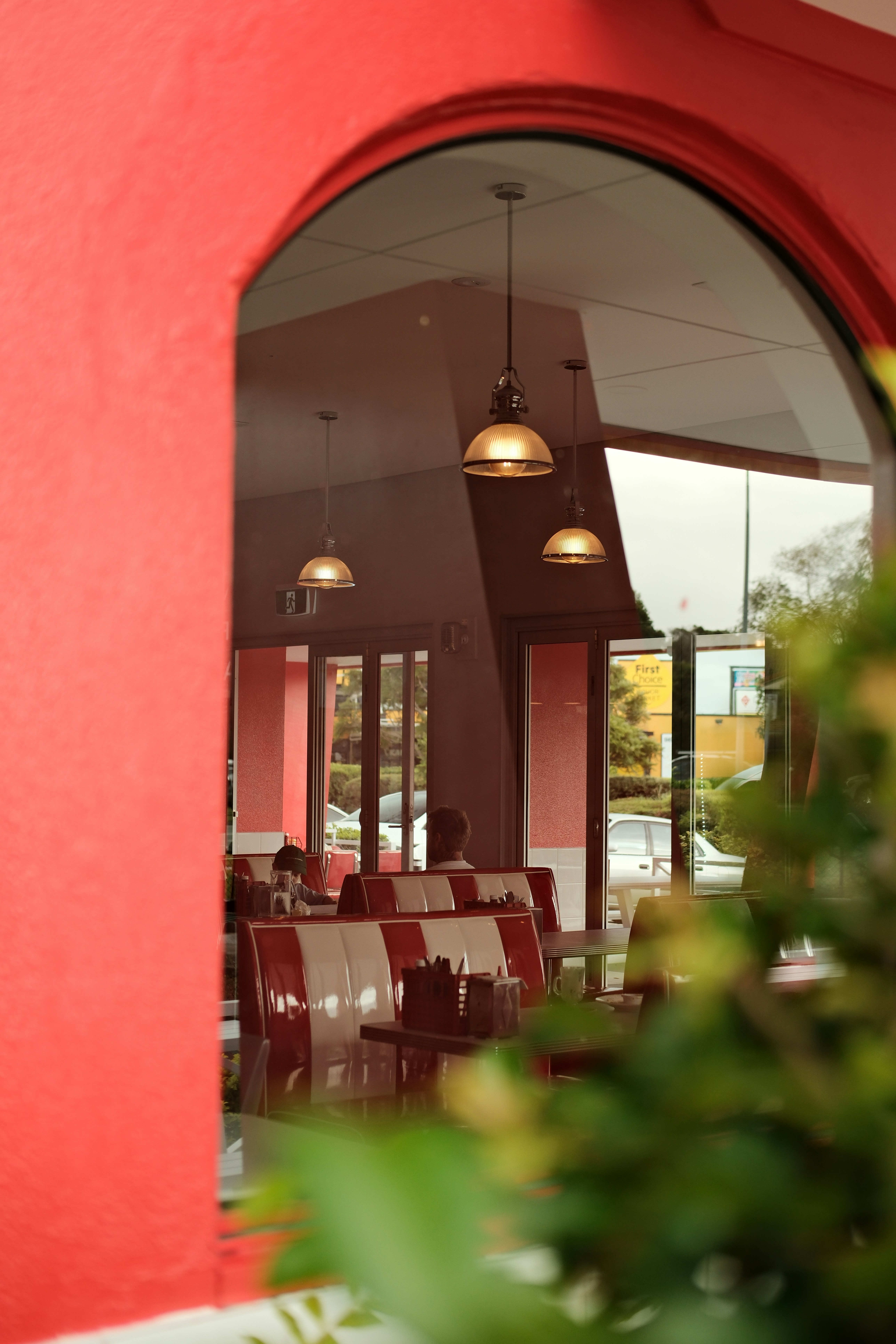 a restaurant with a red wall and red chairs