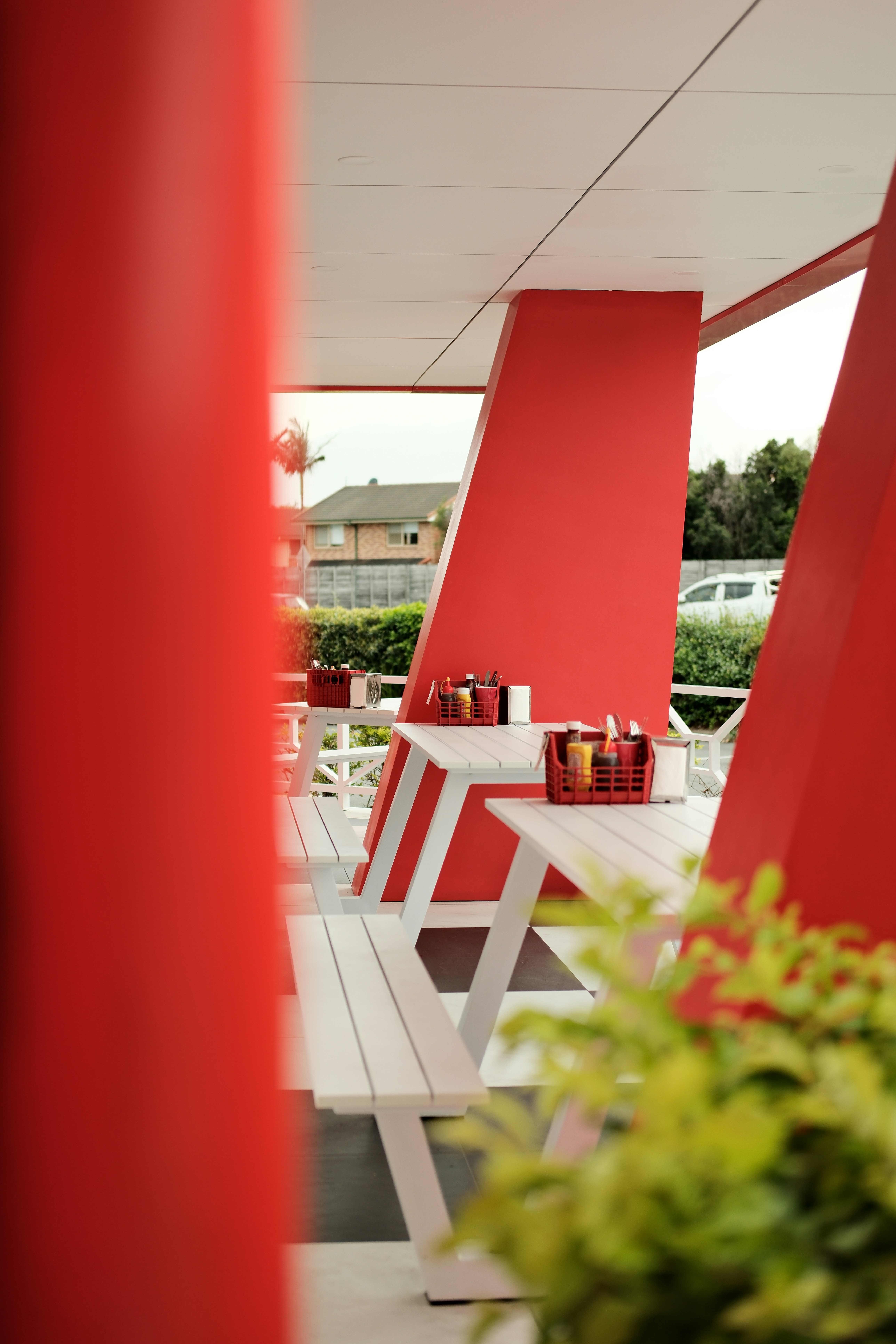 a white bench sitting next to a red wall