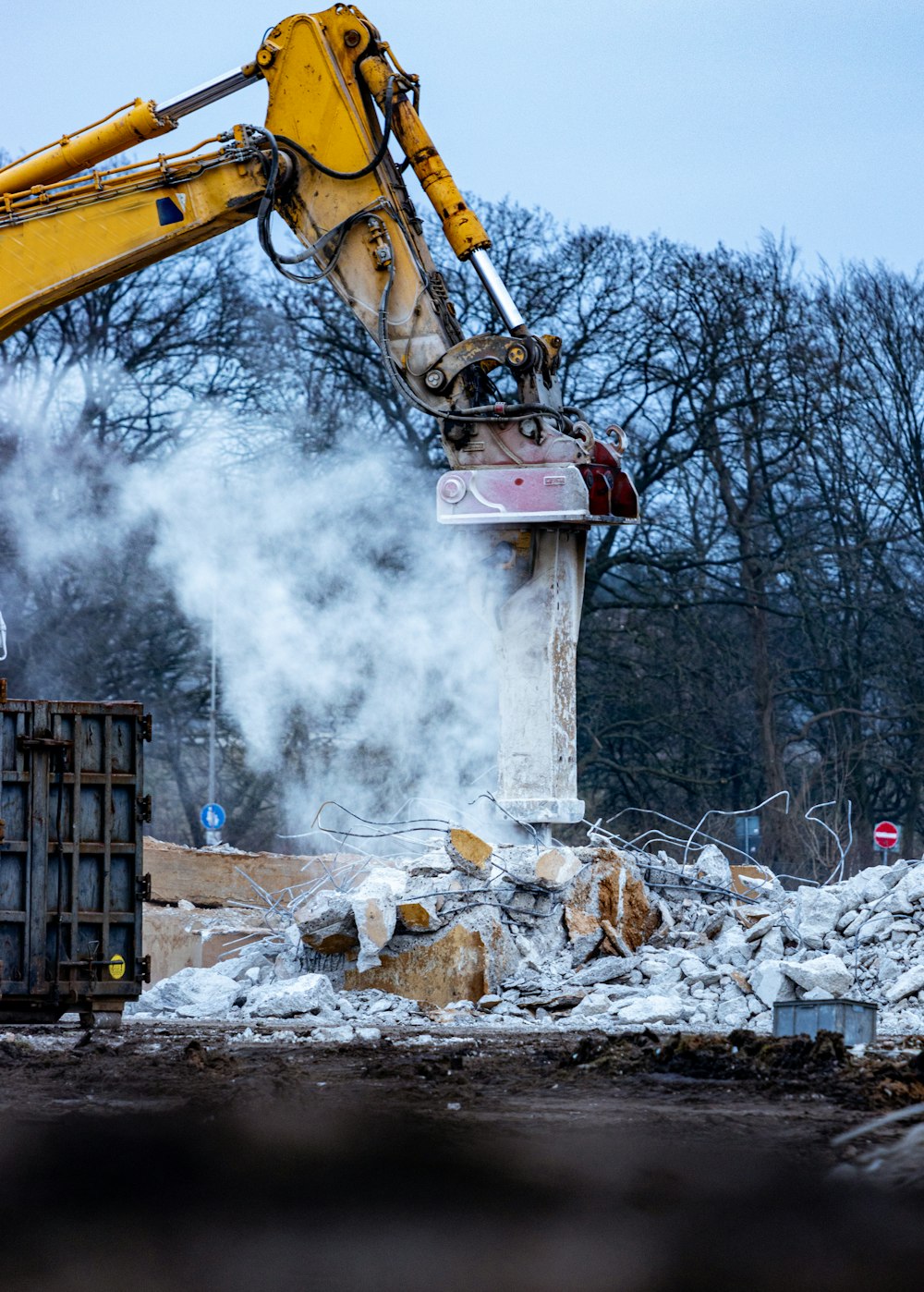 a construction site with a crane and a pile of rubble