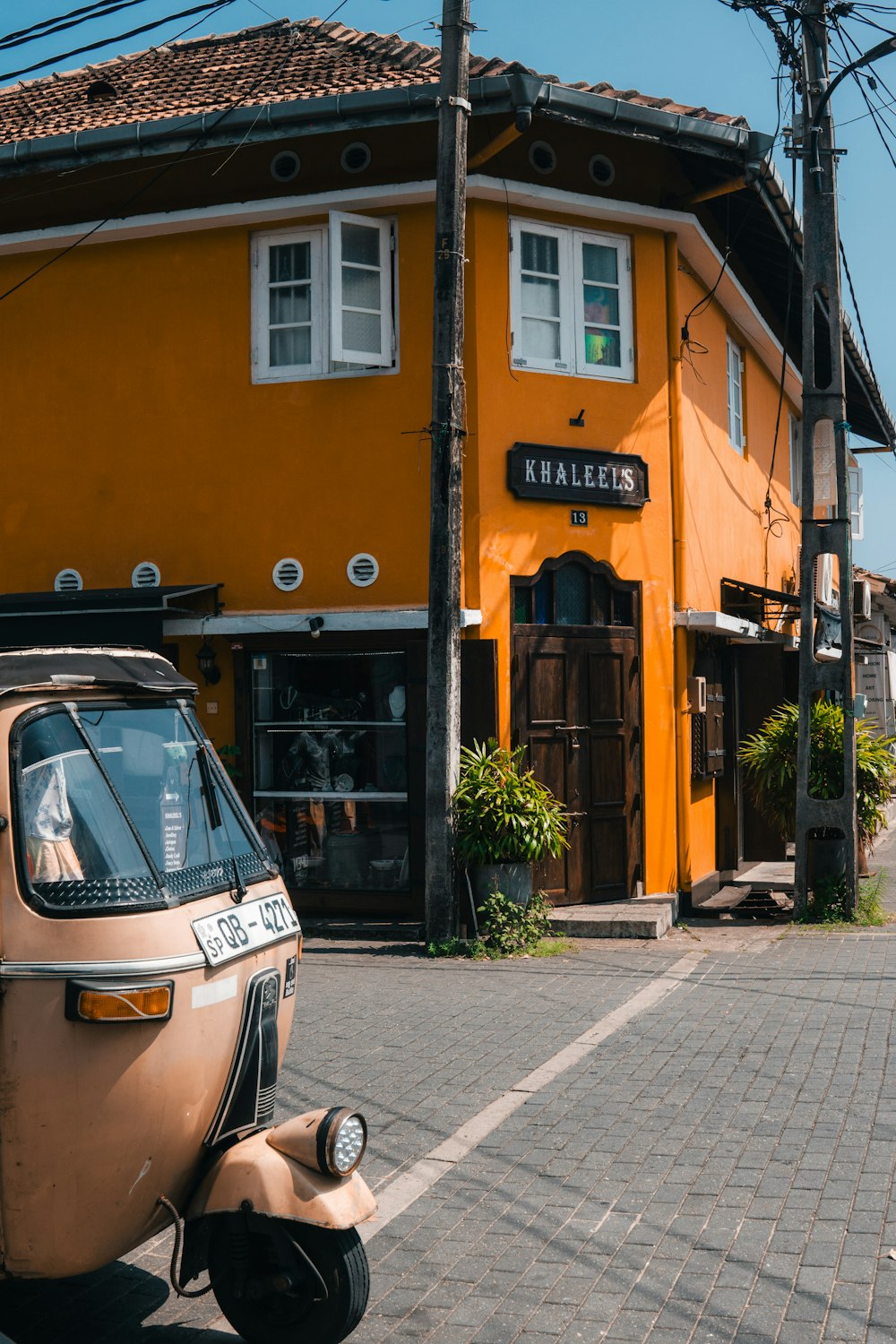 a scooter parked in front of a yellow building