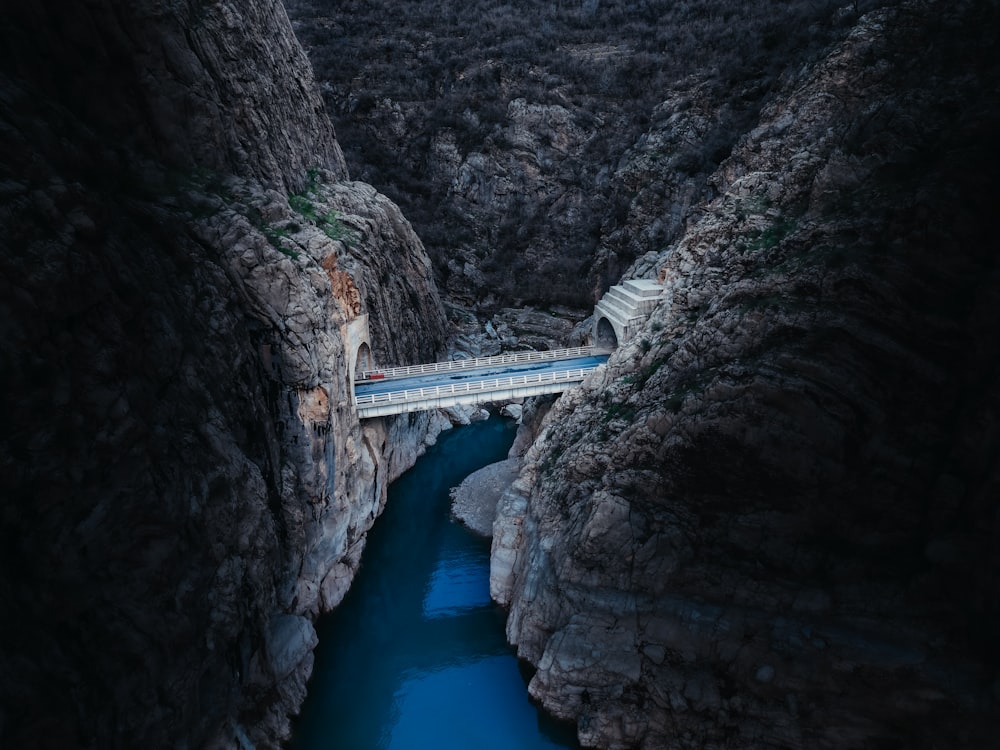 a bridge over a river in a canyon