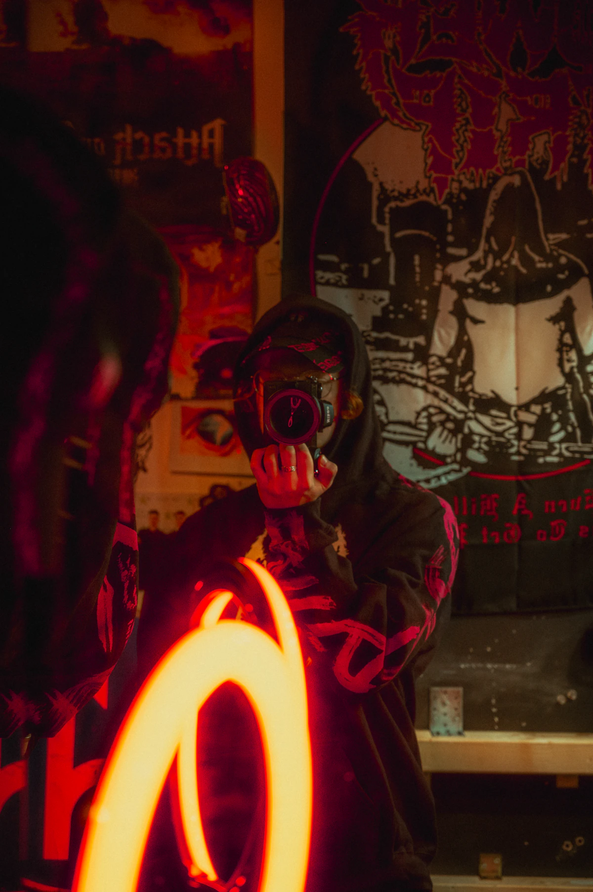 A person in a mask holding a lit up object