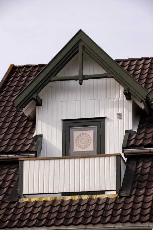 a clock on the side of a white building