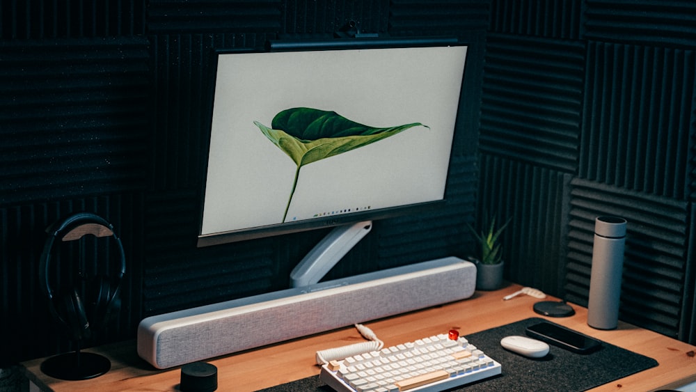 a computer monitor sitting on top of a wooden desk