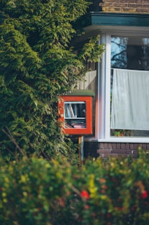 a window with a book shelf in the middle of it