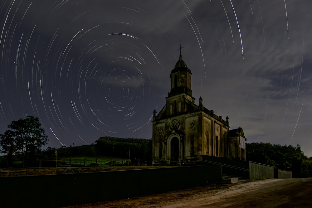 a church with a star trail in the sky