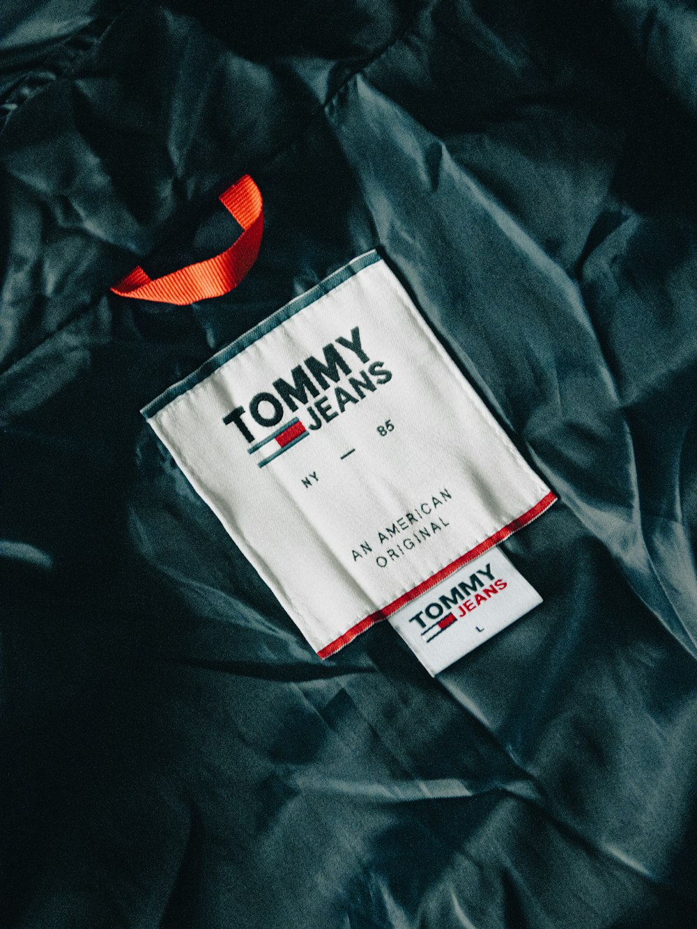 a tommy hilfiger label on a black jacket