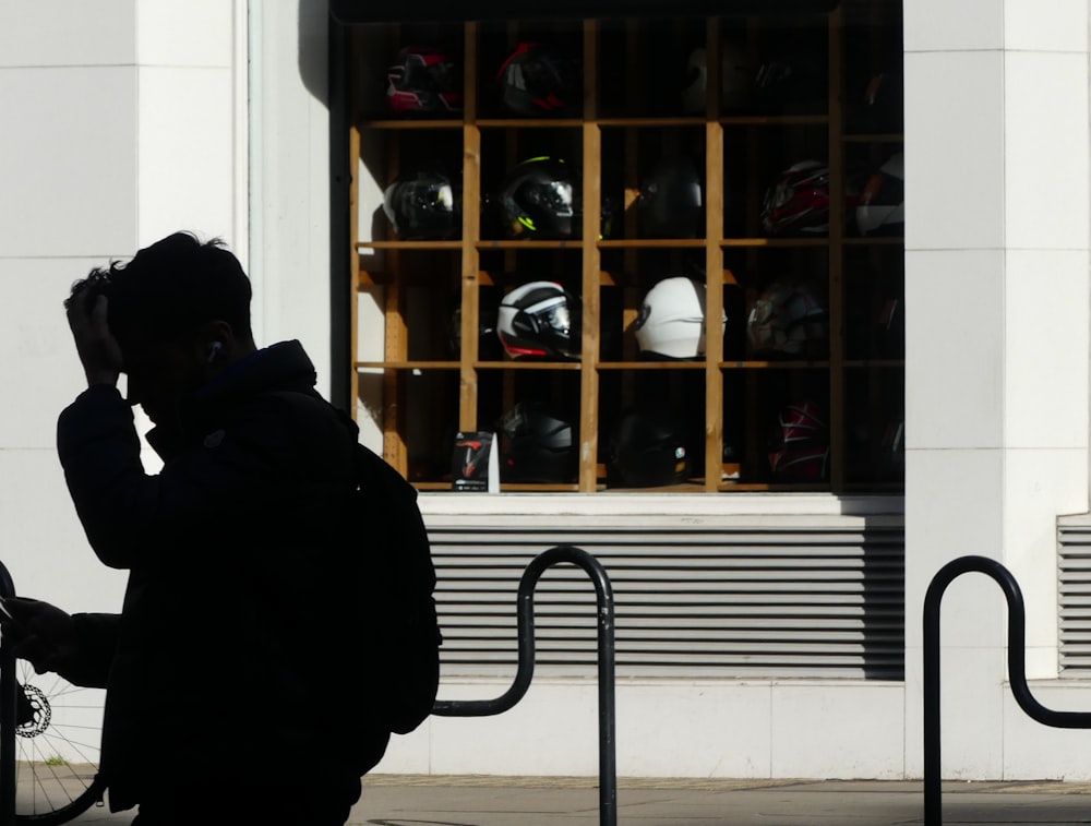 a man talking on a cell phone in front of a store