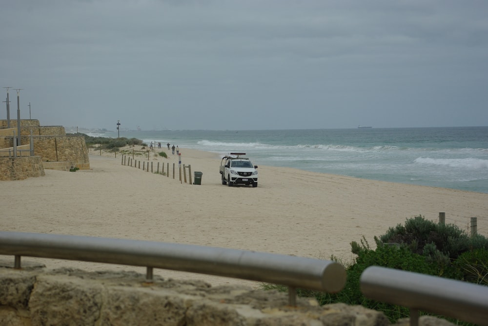 a van is parked on a beach near the ocean