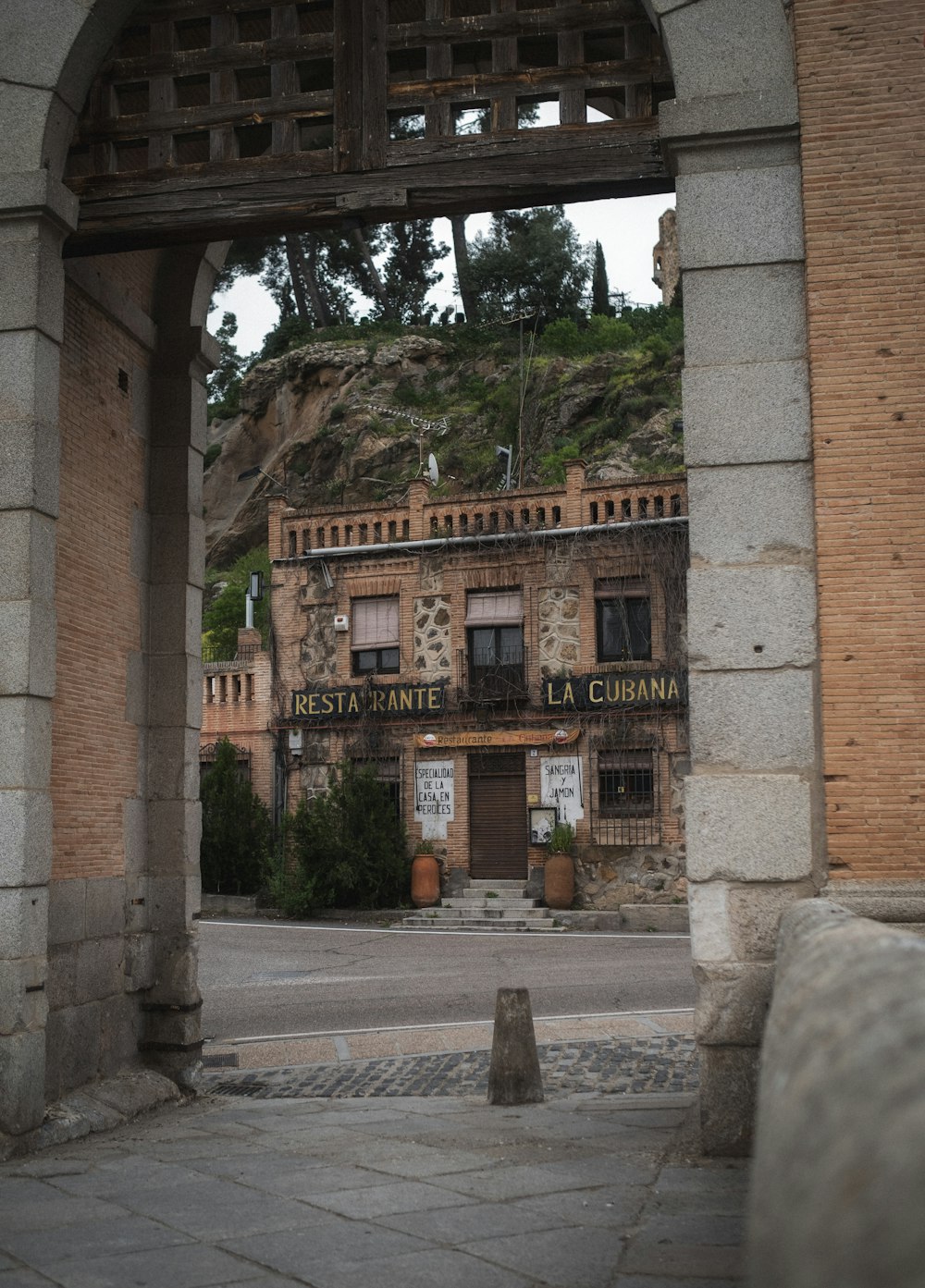 an old building with a stone arch in front of it