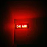 a red neon sign that reads on air