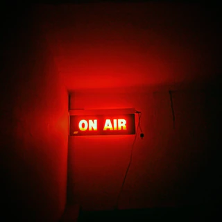 a red neon sign that reads on air