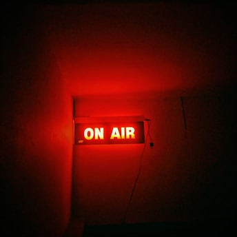 a red neon sign that reads on air