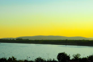 a large body of water with mountains in the background