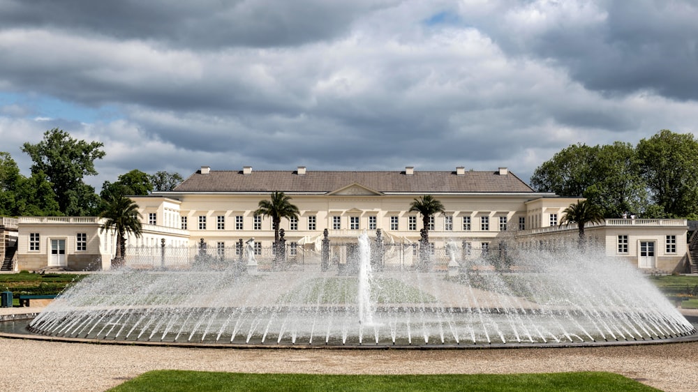 a large building with a fountain in front of it