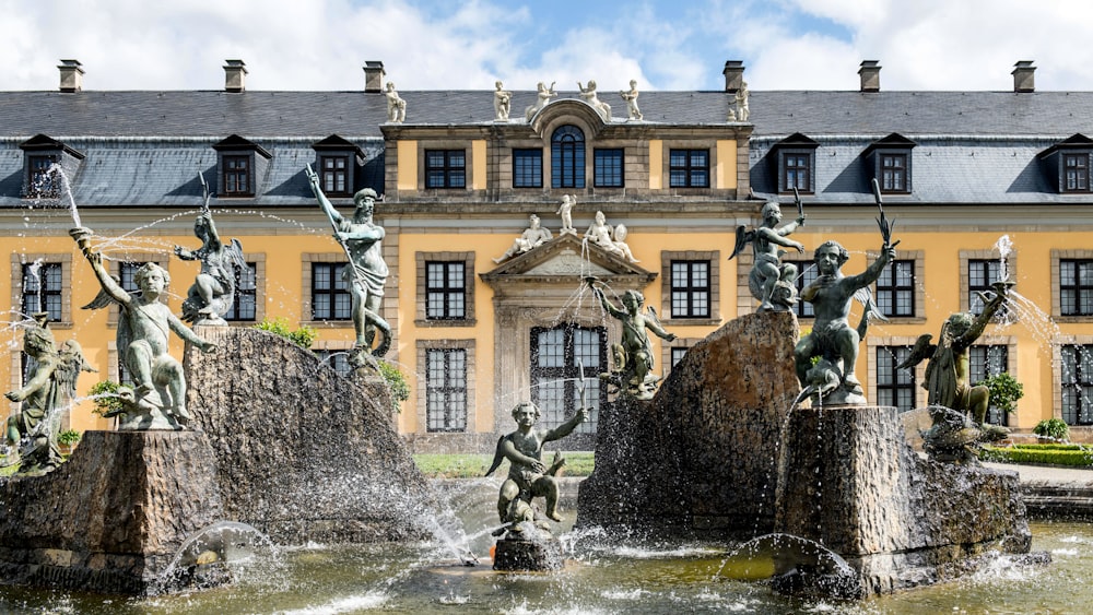 a large building with a fountain in front of it