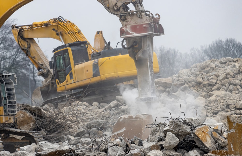 a bulldozer digging through a pile of rubble