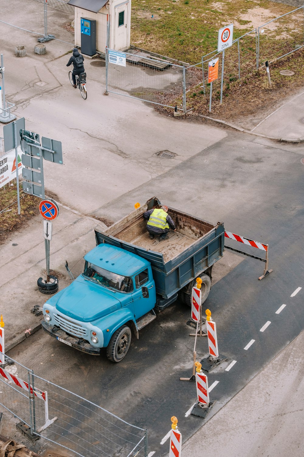 a blue truck parked on the side of a road