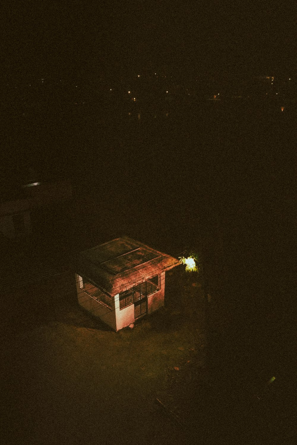 a dark picture of a small building in the dark