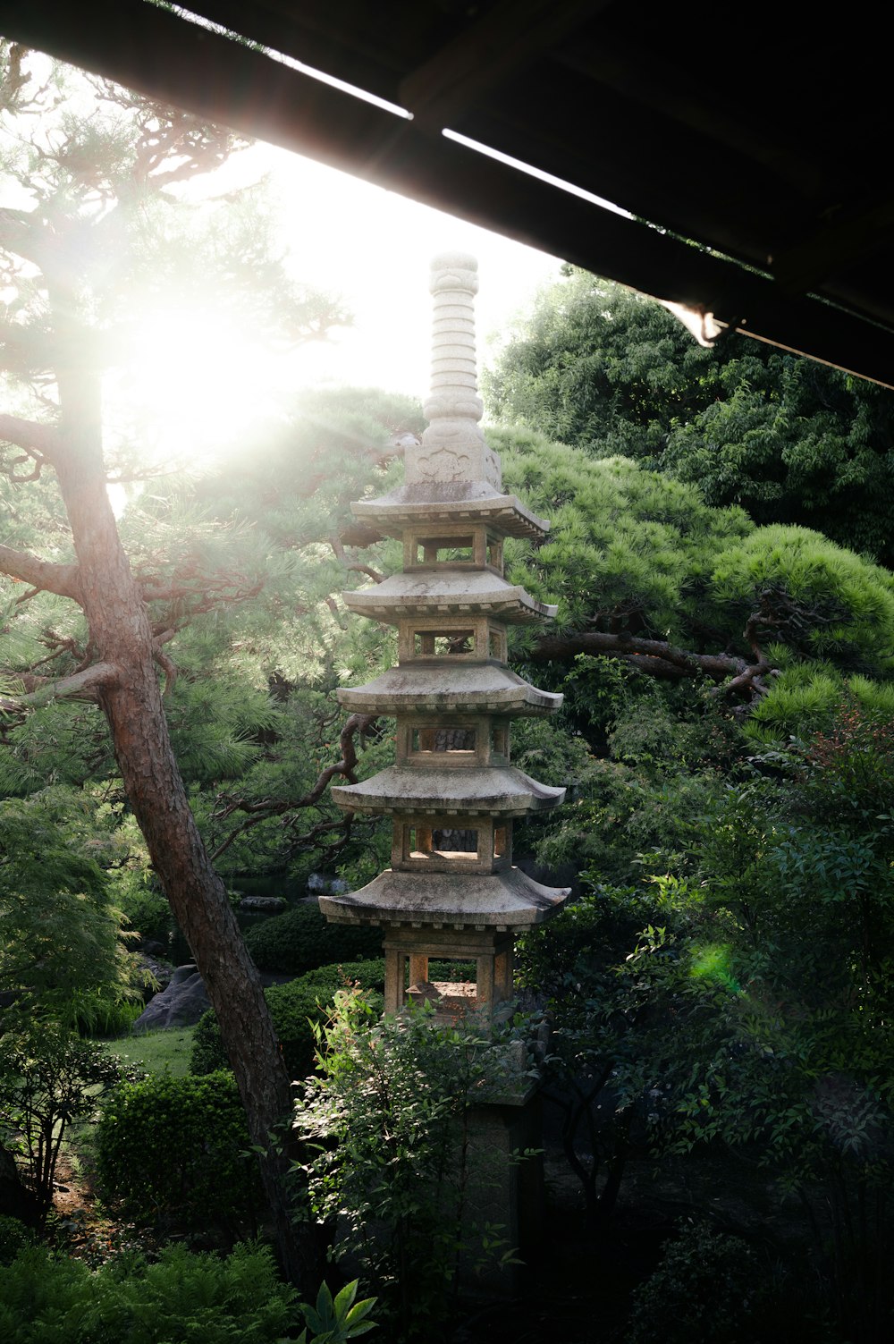 a tall pagoda in the middle of a forest