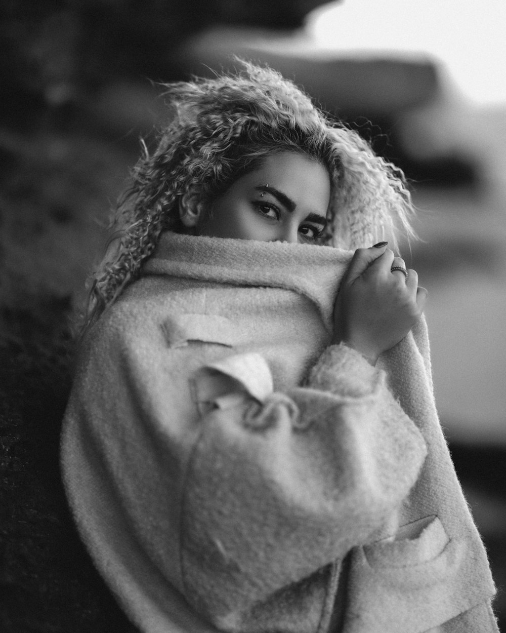 a woman is wrapped up in a blanket