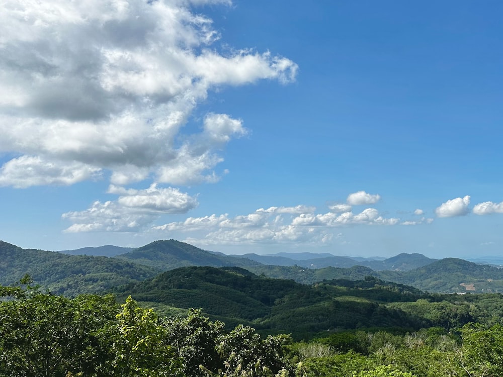 a scenic view of a mountain range with clouds in the sky