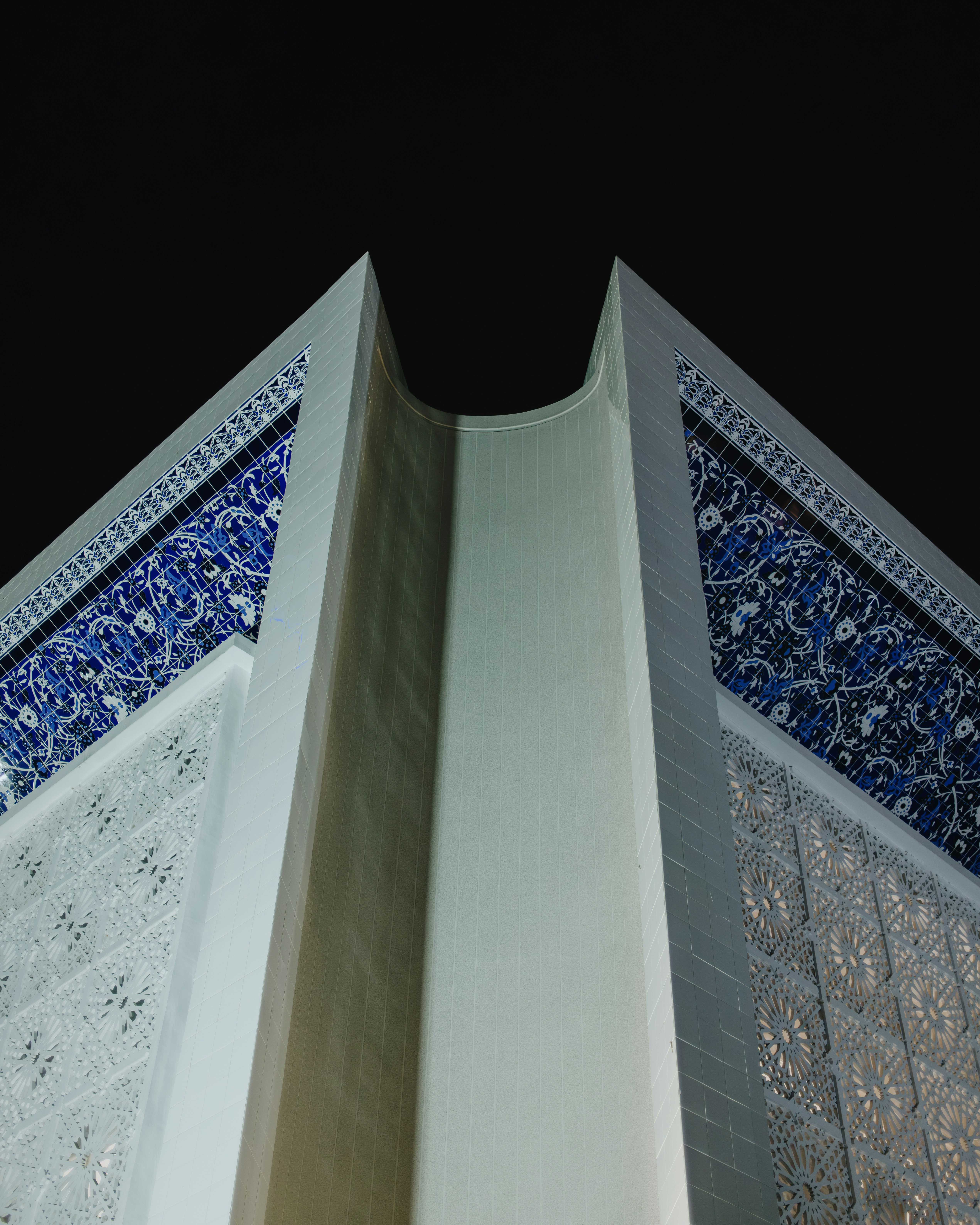 a tall building with a blue and white design on it's side