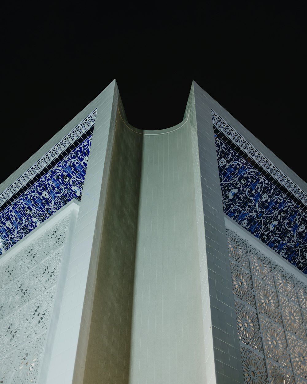 a tall building with a blue and white design on it's side