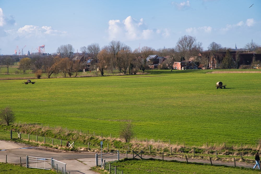 a large open field with a few people walking around it