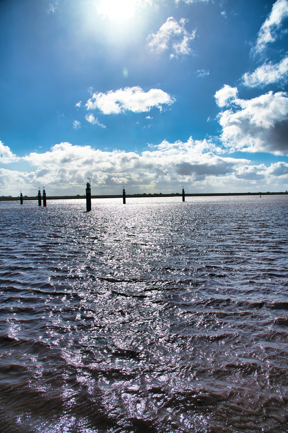 a body of water with a bridge in the background