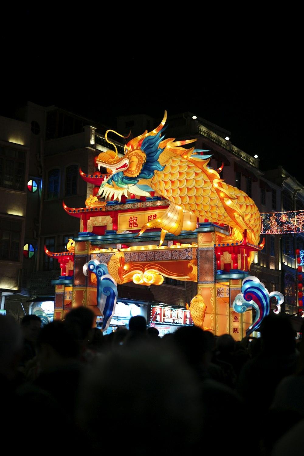 a dragon statue is lit up at night