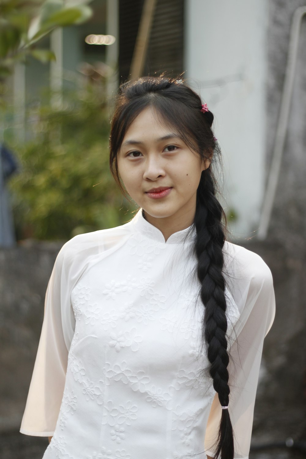 a woman in a white dress with a long braid