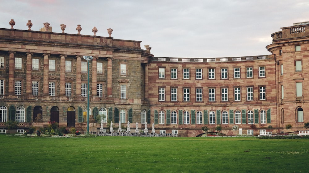 a large building with many windows and statues on top of it